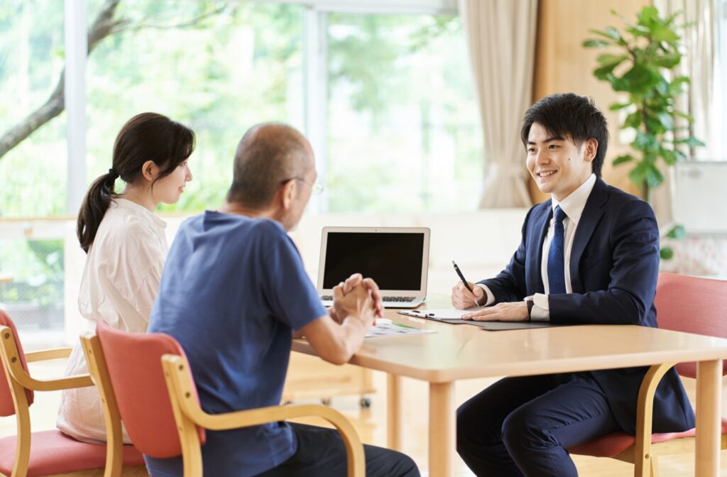 Lawyer having a meeting with a daughter and her elderly father.